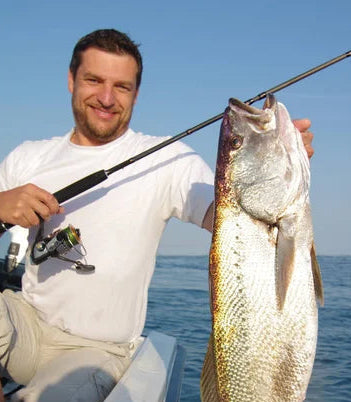 files/depositphotos_312573600-stock-photo-boat-sea-fishing-man-holding.webp